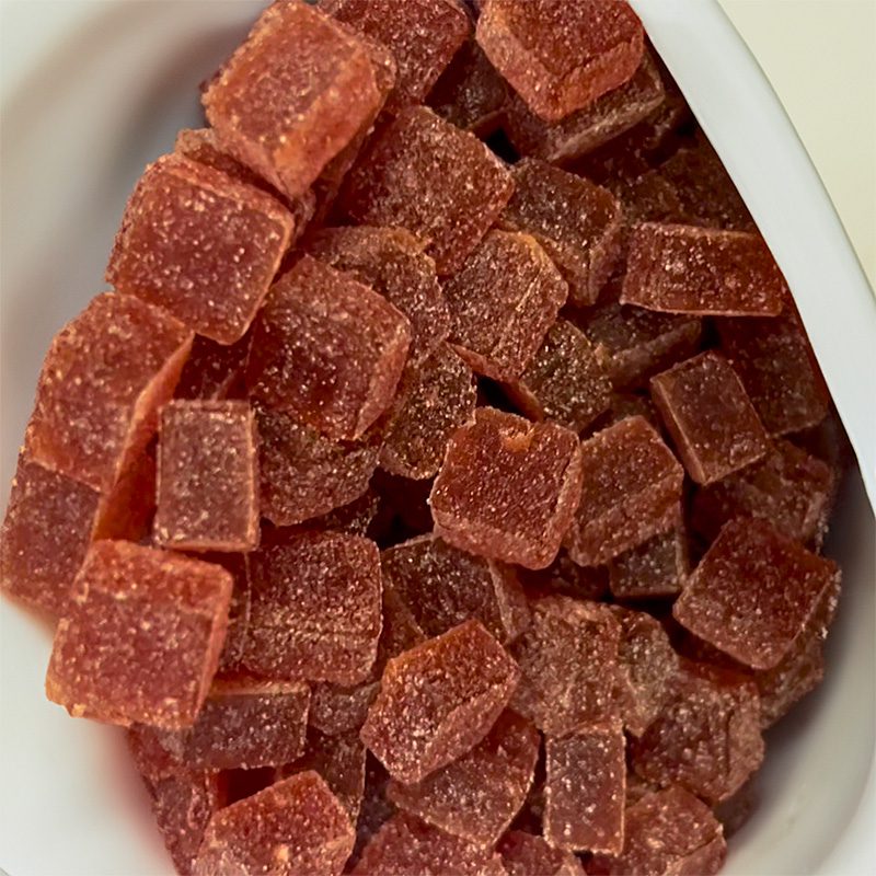 Close-up of strawberry Amanita Muscaria gummies in a bowl