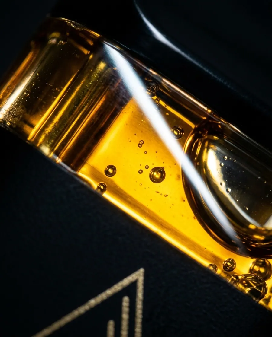 Macro view of golden oil inside Standard vaporizer hardware