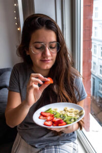 Woman holding a plate of food.